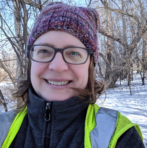 Selfie with a winter hat and a green safety vest.