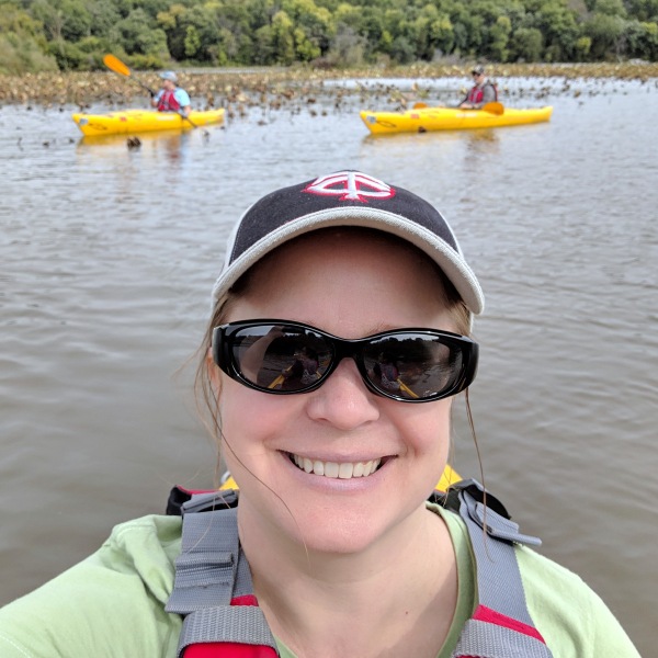 Selfie taken from a kayak, with two kayakers in the background.